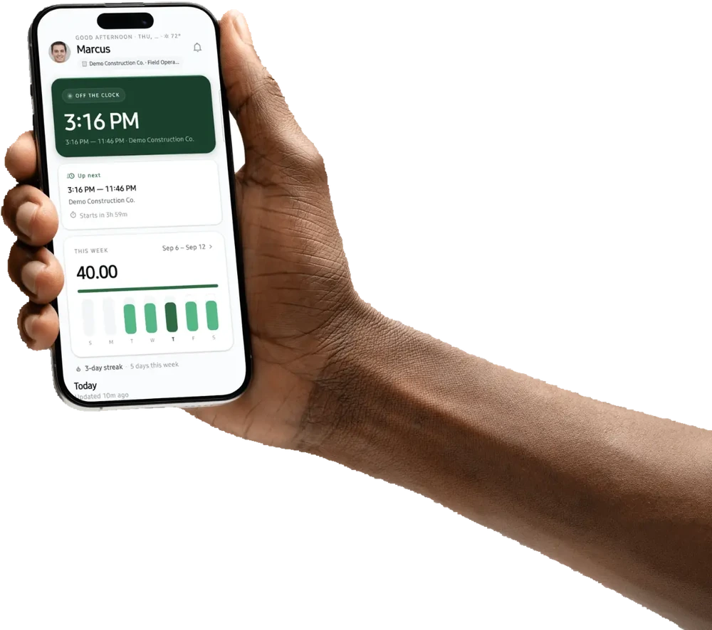 A hand holding a phone running the VEA app: the clock-in card, the next shift, and this week's hours.